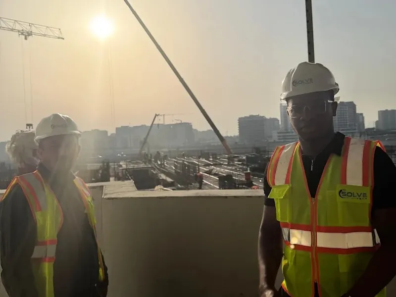 Engineer surveying a rooftop plant area before an energy upgrade